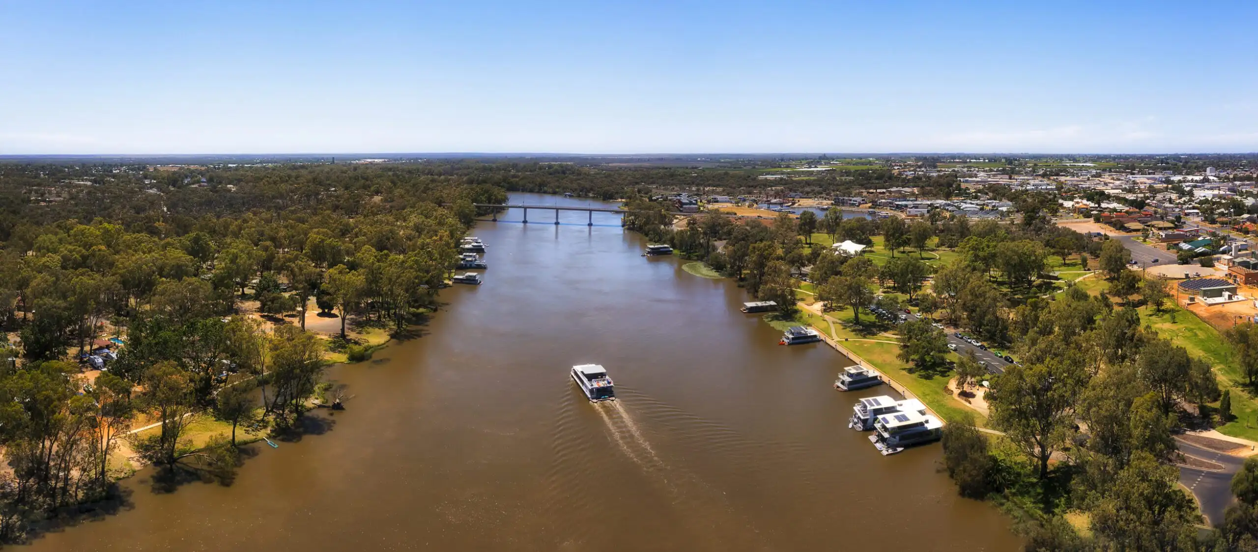 D Mildura River boat 2 bridge pan Wide Murray river at Mildura city of Australian Riverina in aerial panorama with cruise boat.