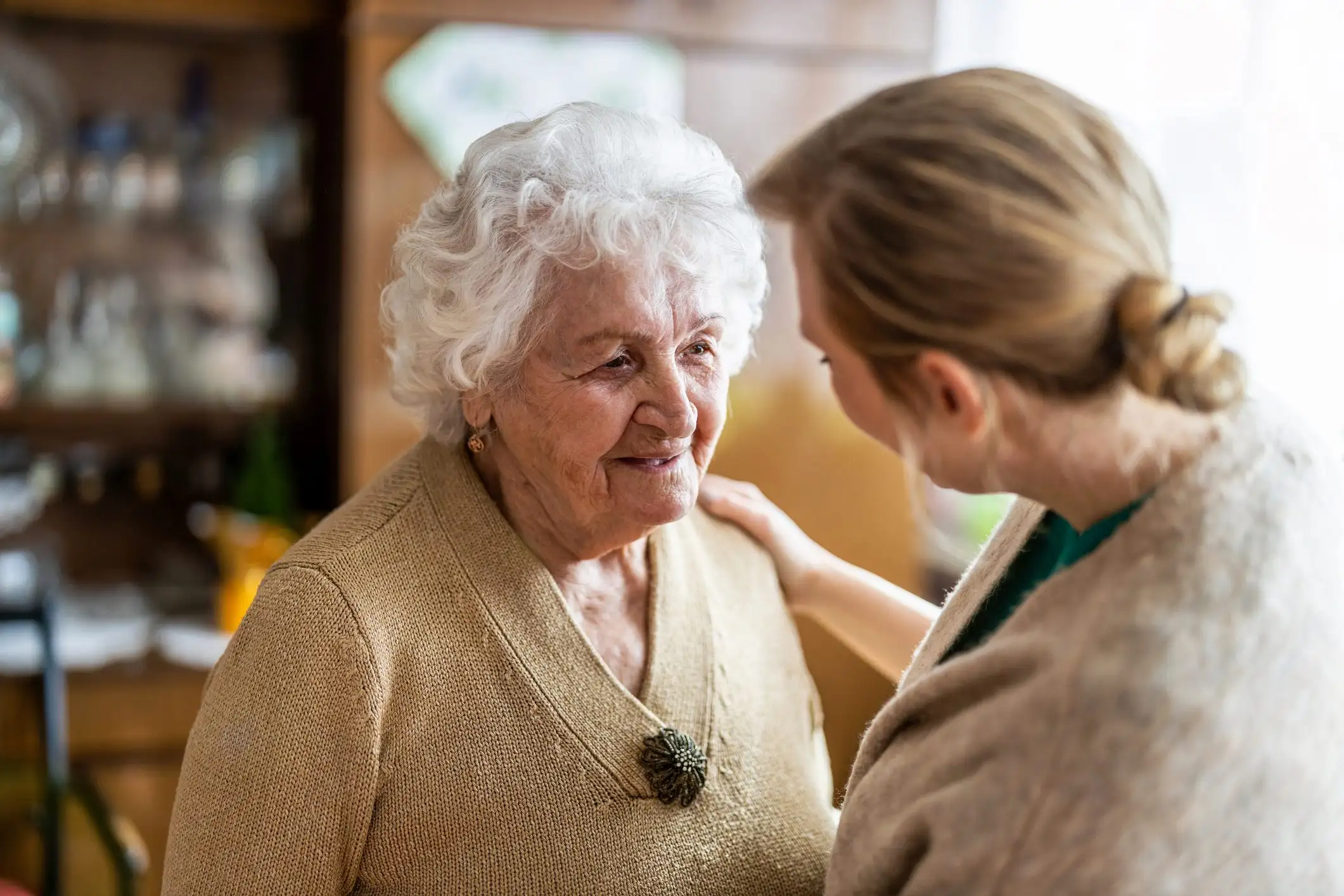 Health visitor talking to a senior woman during home visit Health visitor talking to a senior woman during home visit